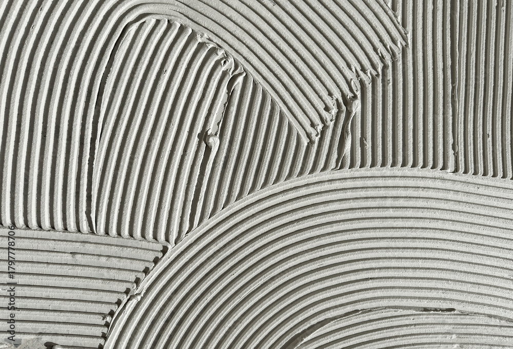 Fototapeta premium Construction Adhesive Texture with Curved Grooves and Linear Ridges