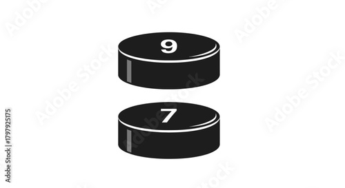 Black pucks with numbers nine and seven on white background