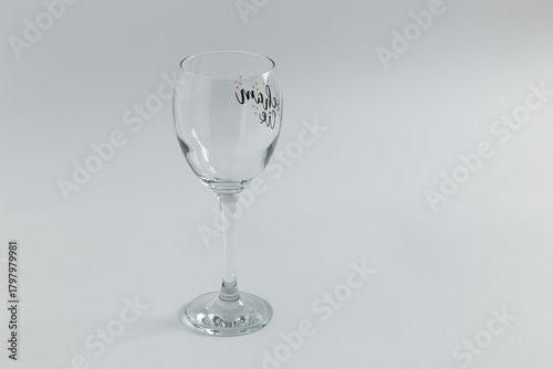 Empty wine glass on light studio background
