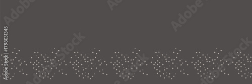 A dark gray background with scattered small white objects arranged in a horizontal pattern near the bottom