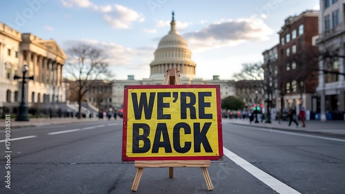 Bold yellow sign with we re back text stands prominently in empty street facing capitol building