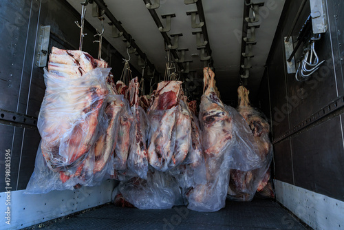Raw beef carcasses hanging in cold storage truck