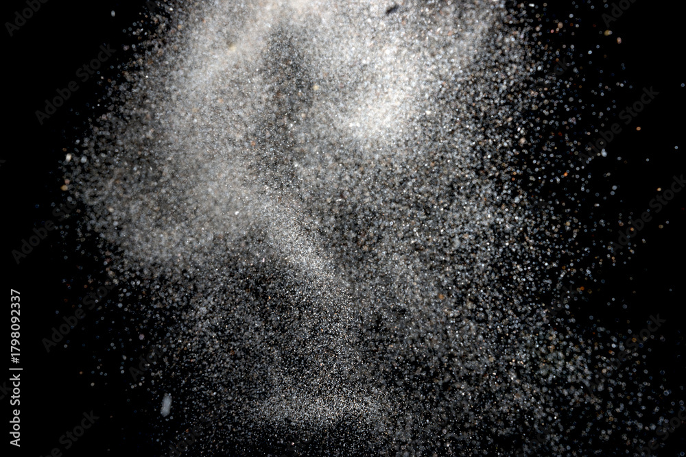 Obraz premium White dust particles explosion on black background
