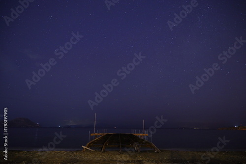 Fototapeta Naklejka Na Ścianę i Meble -  Abandoned pier under the stars in the Aegean Sea.