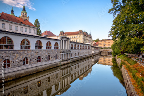 Fototapeta Naklejka Na Ścianę i Meble -  Ljubljana, Slovenia – July 14, 2025: A scenic view of the Ljubljanica River as it winds through the historic center of Ljubljana.