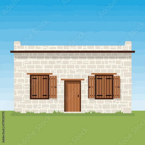Charming stone house facade with wooden shutters and blue sky backdrop