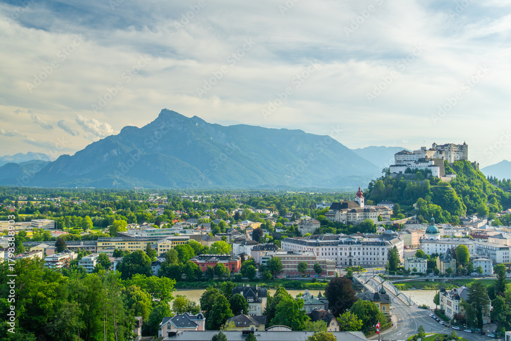Obraz premium Salzburg City and Hohensalzburg Fortress on Sunny Summer Day. Mountains in Background. Austria