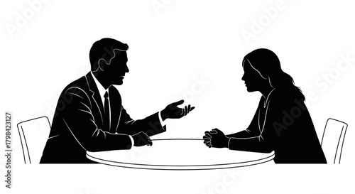 Two people in silhouette, one gesturing, sit at a round table in a meeting