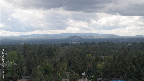 Overlooking Bend, Oregon toward Cascade Mountain range under cloudy sky