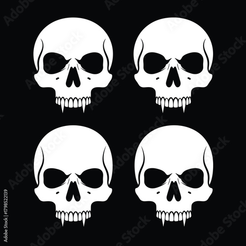 Four white skulls with fangs on