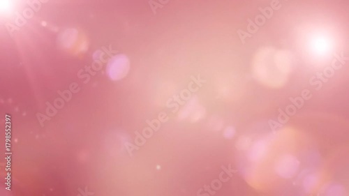 Soft, rose-colored abstract background with bright lens flares