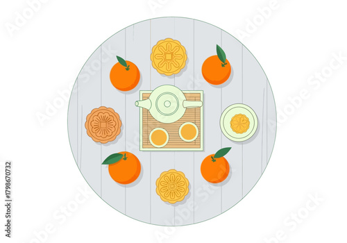 Citrus fruits and tea set arranged on a wooden table.