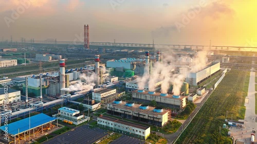Aerial shot of an oil refinery and chemical plant with industrial equipment at sunrise