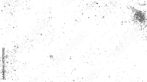 Scattered grey dust particles and specks on a white background creating a textured grunge effect speckle