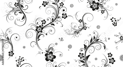 Seamless decorative pattern featuring graceful black floral motifs, swirling tendrils, and scattered tiny flowers on a crisp white backdrop.