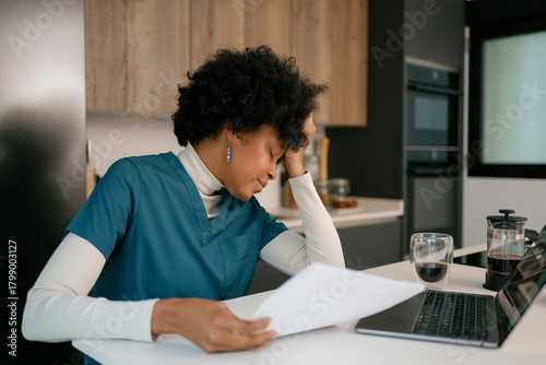 Overworked doctor experiencing burnout and stress at home