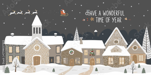 Charming snow covered village scene with santa and reindeer flying overhead during winter holidays