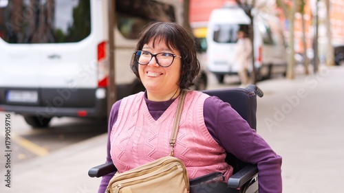 Woman in wheelchair smiling arriving with accessible transport
