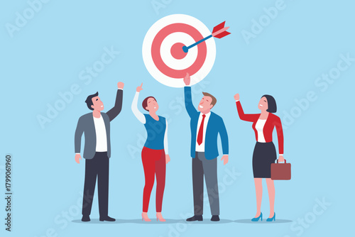 Diverse team of business professionals celebrating achieving a shared goal with a bullseye and arrow