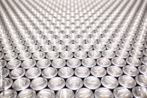 Close-up of aluminum cans on a conveyor belt. Plant for the production of energy drinks. Conveyor line for the production of beverages. Industrial production of food products.