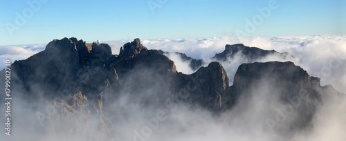 Mountain trail Pico do Arieiro, Madeira Island, Portugal Scenic view of steep and beautiful mountains and clouds during sunrise. 