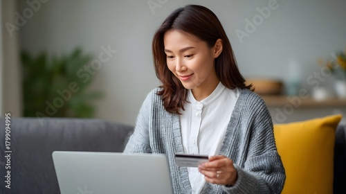 Woman using credit card on laptop for online shopping