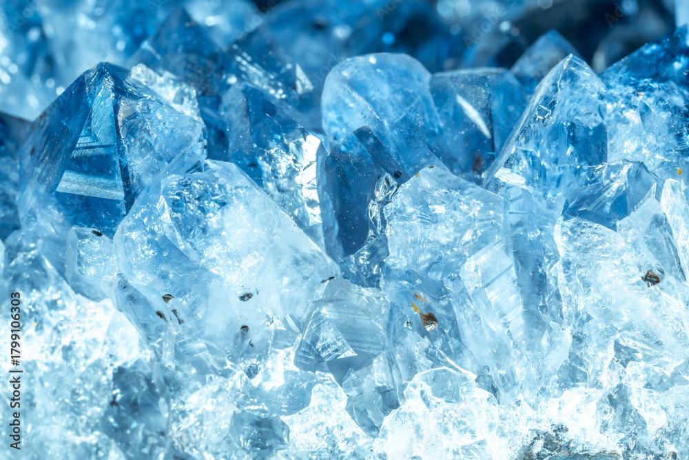 Obraz premium Blue Crystal Mineral Stone. Gems. Mineral crystals in the natural environment. Texture of precious and semiprecious stones. Seamless background with copy space colored shiny surface of precious stones