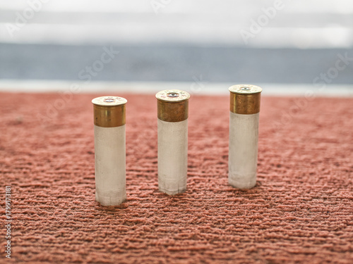 Shotgun shells on a red background at a shooting range