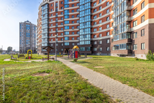 Modern Residential Building with Playground and Green Yard