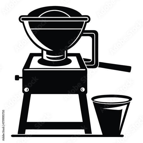 Black and white grinder machine stands near the container, ready to grind the foods