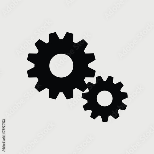 Two black interlocking gears on a light gray background