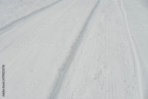 Winter Road with Tire Tracks in Fresh Snow