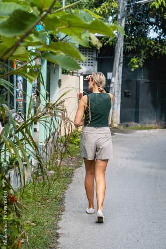 Woman walking down tropical street
