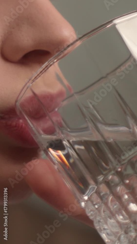 Close up thirsty woman girl drinking clean water in morning healthy habit hydration balance smiling Caucasian female drink glass mineral refresh wellness beauty routine freshness health care start day
