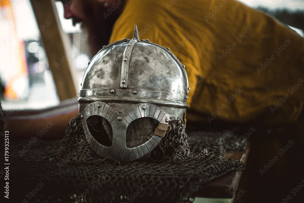 Fototapeta premium A beautiful knight's helmet lies on the table. A metal helmet.