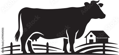 Black silhouette of a cow in a pasture with a barn and fence