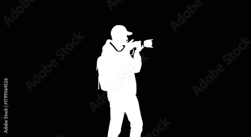 Silhouette of a person holding a camera, capturing a moment, against a dark background.