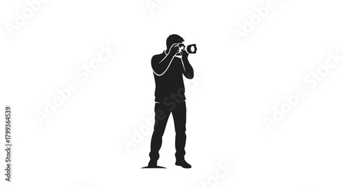Silhouette of a photographer holding a camera and taking a picture.