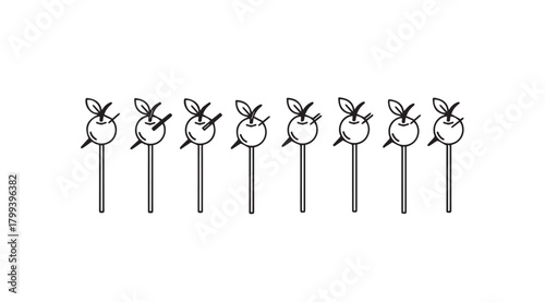 A row of whimsical fruit or vegetable silhouettes on sticks silhouette