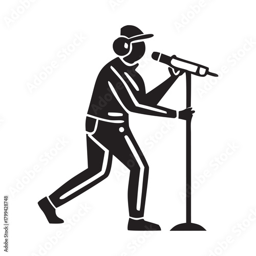 Silhouette of a person wearing headphones and a baseball cap singing into a microphone on a stand