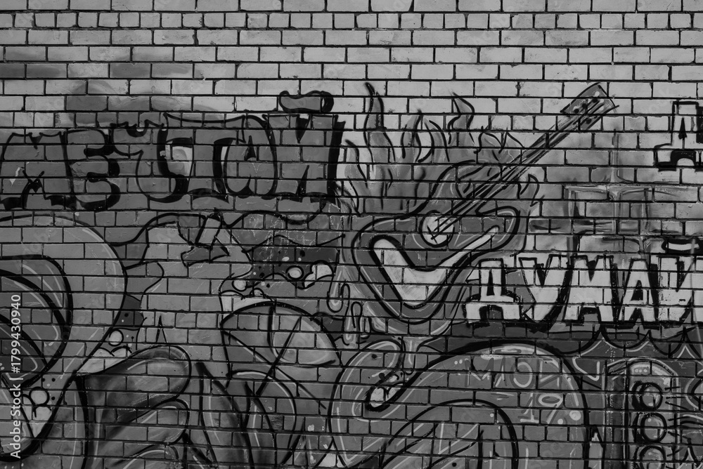 Naklejka premium Colorful urban graffiti with guitar on brick wall
