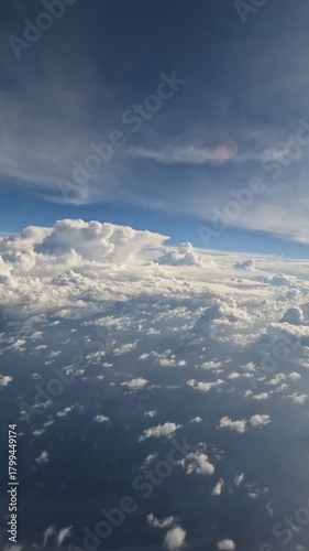 Heavy clouds covering the French Alps, filmed from an airplane window, showing dramatic aerial scenery above the mountains.