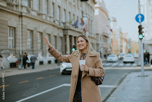 Woman waving while holding ...