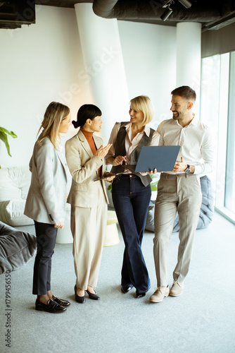 Professional team collaborating in a modern office setting during afternoon