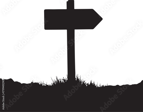 Black silhouette of a directional signpost in grass