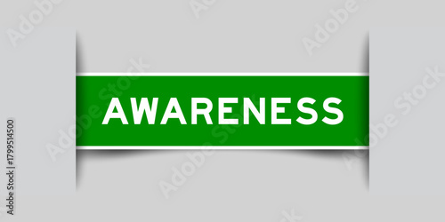 Green color square shape sticker label with word awareness inserted in gray background