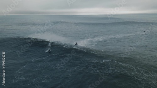 Jet ski surfer conquers massive waves at nazare beach in portugal