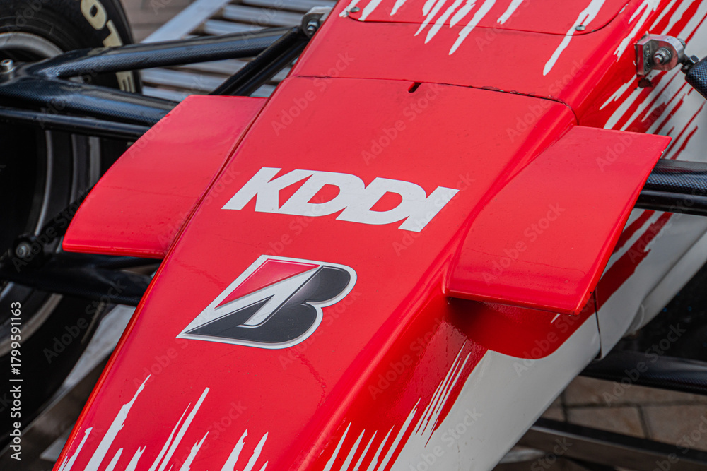 Naklejka premium Red and black Formula 1 Toyota TF-108 car with aerodynamic structure, parked in an urban setting, displaying KASPA and number 5 on the body Natural daylight - Kyiv, Ukraine 10-10-2024