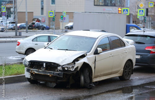 A white, damaged car after an accident stands on the street, Pyatiletka Avenue, Saint Petersburg, Russia, November 16, 2025