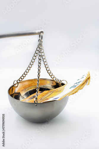 50 Euro banknotes on balance scale symbolizing financial justice concept.